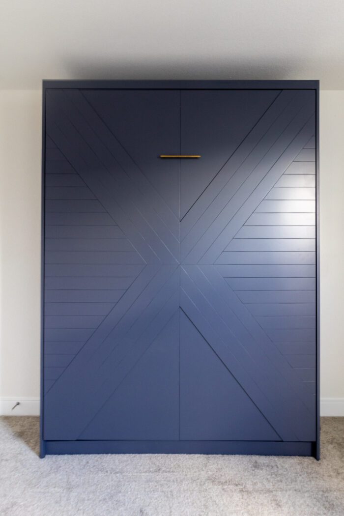 Queen vertical Enfield Murphy bed with X-formed panel doors, painted navy blue with brass hardware, Austin TX