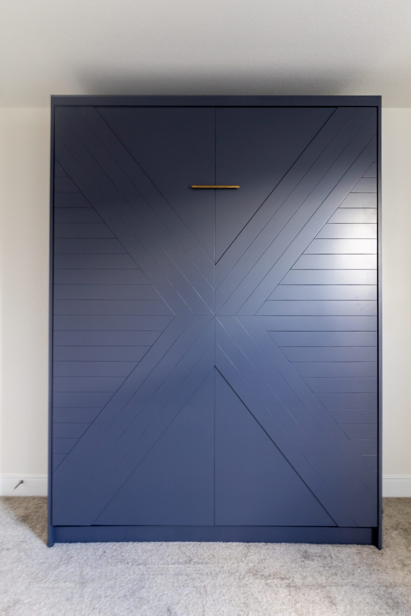 Queen vertical Enfield Murphy bed with X-formed panel doors, painted navy blue with brass hardware, Austin TX