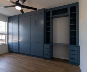 Side view of vertical queen Murphy bed with custom-built desk