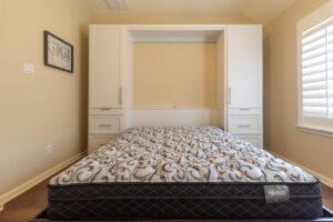 Vertical queen Murphy bed with custom cabinets in open position