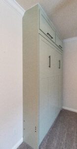 Side view of vertical queen Murphy bed ties into the ceiling