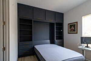 Vertical queen Murphy bed with custom cabinets in open position.