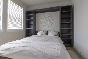 Vertical queen Murphy bed with wall decor in open position