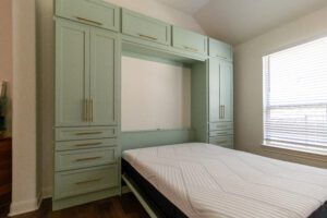 Vertical queen Murphy bed with custom cabinetry in open position