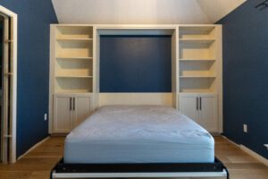 Vertical queen Murphy bed with cabinets in open position