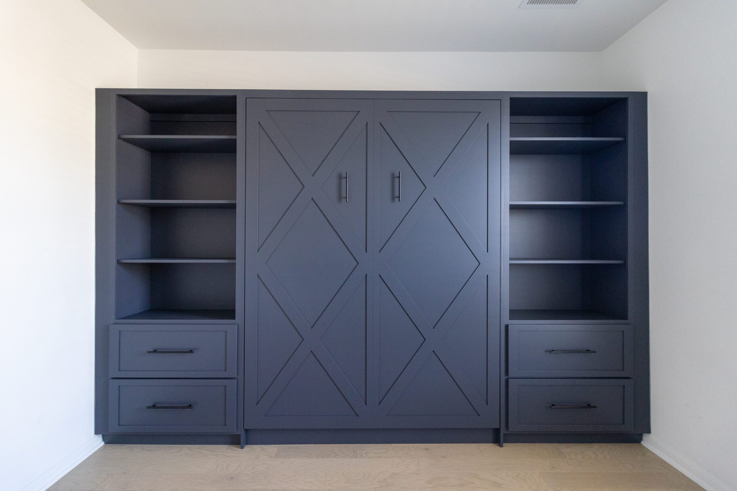 Queen vertical Crestview Murphy bed with flanking open shelving towers and drawer bases, painted charcoal gray, Austin TX