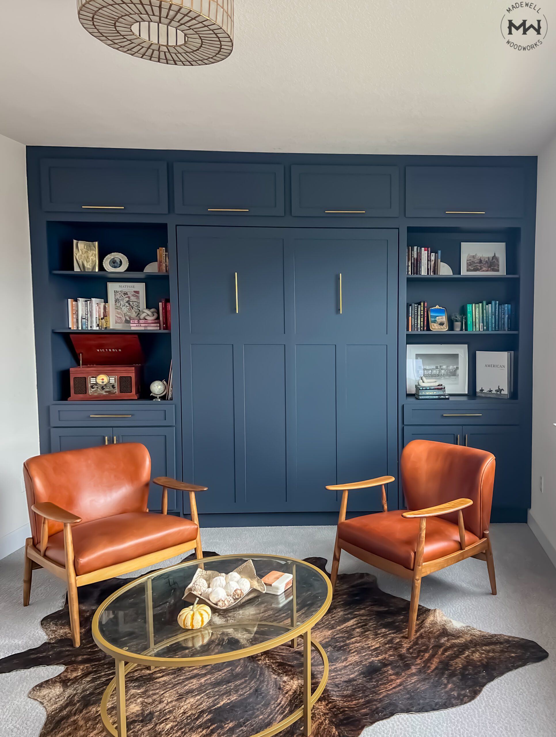 Queen vertical Craftsman Murphy bed with full built-in cabinetry and open shelving, painted navy blue, Austin TX