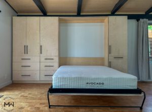 Baltic birch Murphy bed with black hardware and modern built-in cabinetry, handcrafted by Madewell Woodworks in Austin, Texas.