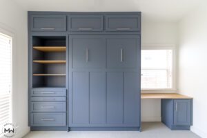 Blue Craftsman Murphy bed with built-in desk, shelving, and modern hardware, handcrafted by Madewell Woodworks in Austin, Texas.
