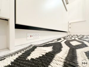 Built-in USB and power outlet beneath a custom Murphy bed, crafted by Madewell Woodworks in Austin, Texas.