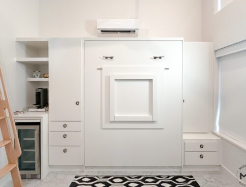 Custom Murphy Bed with Folding Desk and Beverage Nook | Madewell Woodworks Austin - Madewell Woodworks Custom white Murphy bed with folding dek front, built-in drawers, and beverage nook, handcrafted by Madewell Woodworks in Austin, Texas.