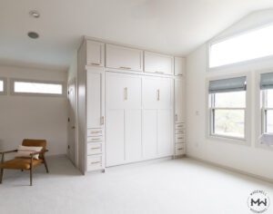 Custom king-size Murphy bed with shaker-style trim, built-in cabinetry, and vaulted ceilings, handcrafted by Madewell Woodworks in Austin, Texas.