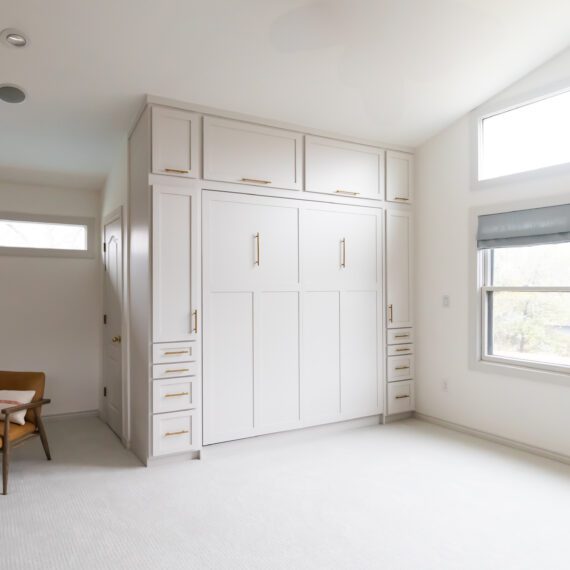 Custom king-size Murphy bed with shaker-style trim, built-in cabinetry, and vaulted ceilings, handcrafted by Madewell Woodworks in Austin, Texas.