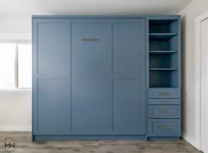 King Shaker Murphy bed in blue with built-in shelving and brass hardware, handcrafted by Madewell Woodworks in Austin, Texas.