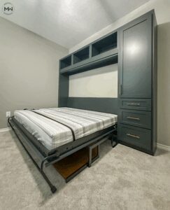 Custom deep green horizontal Murphy bed with brass hardware, stay-level desk, and built-in cabinetry, handcrafted in Austin by Madewell Woodworks.