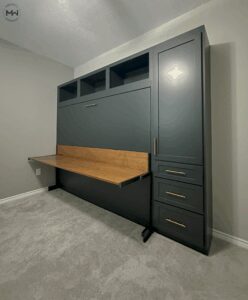 Custom horizontal deep green Murphy bed with a stay-level maple desk and brass hardware, handcrafted in Austin by Madewell Woodworks.