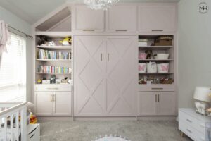 Pink Crestview Murphy bed with built-in shelving and a mermaid wall mural in a nursery.