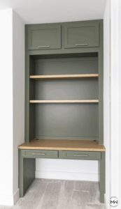 Sage green built-in desk with open shelving and wood accent surfaces, handcrafted by Madewell Woodworks in Austin, Texas.