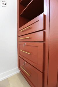 Close-up of red Shaker Murphy bed with keyed file drawers and gold hardware, handcrafted by Madewell Woodworks in Austin, Texas.