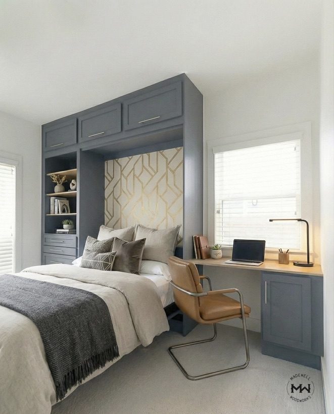Custom charcoal blue Murphy bed with a built-in desk, shelving, and geometric wallpaper accent in an Austin, TX home office.