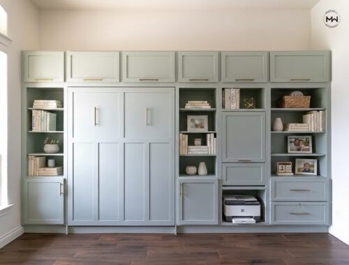 Custom sage green built-in wall unit with a hidden Murphy bed and desk, integrated library shelving, and gold hardware.