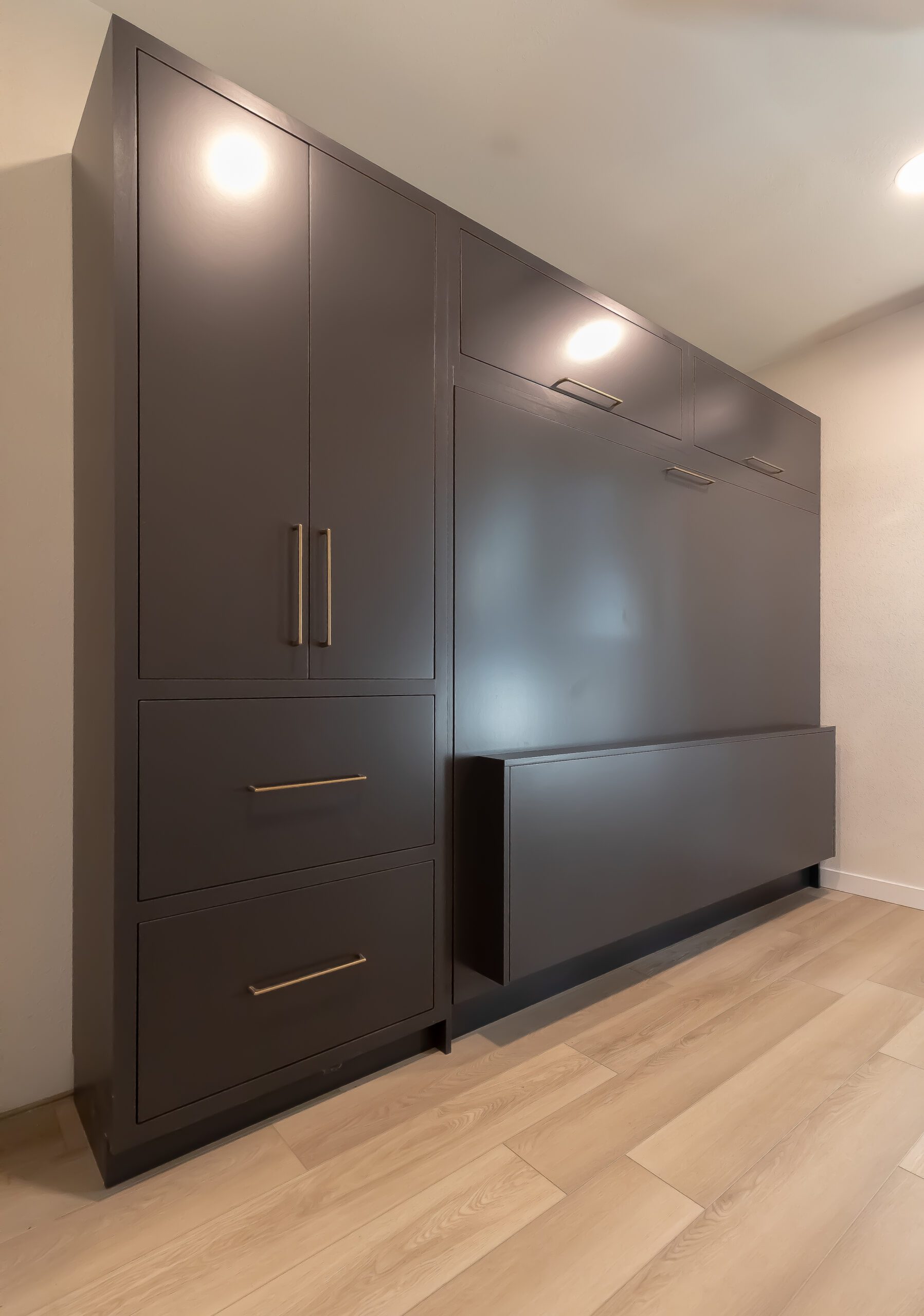 Black queen horizontal Murphy bed with drop down desk in the closed position