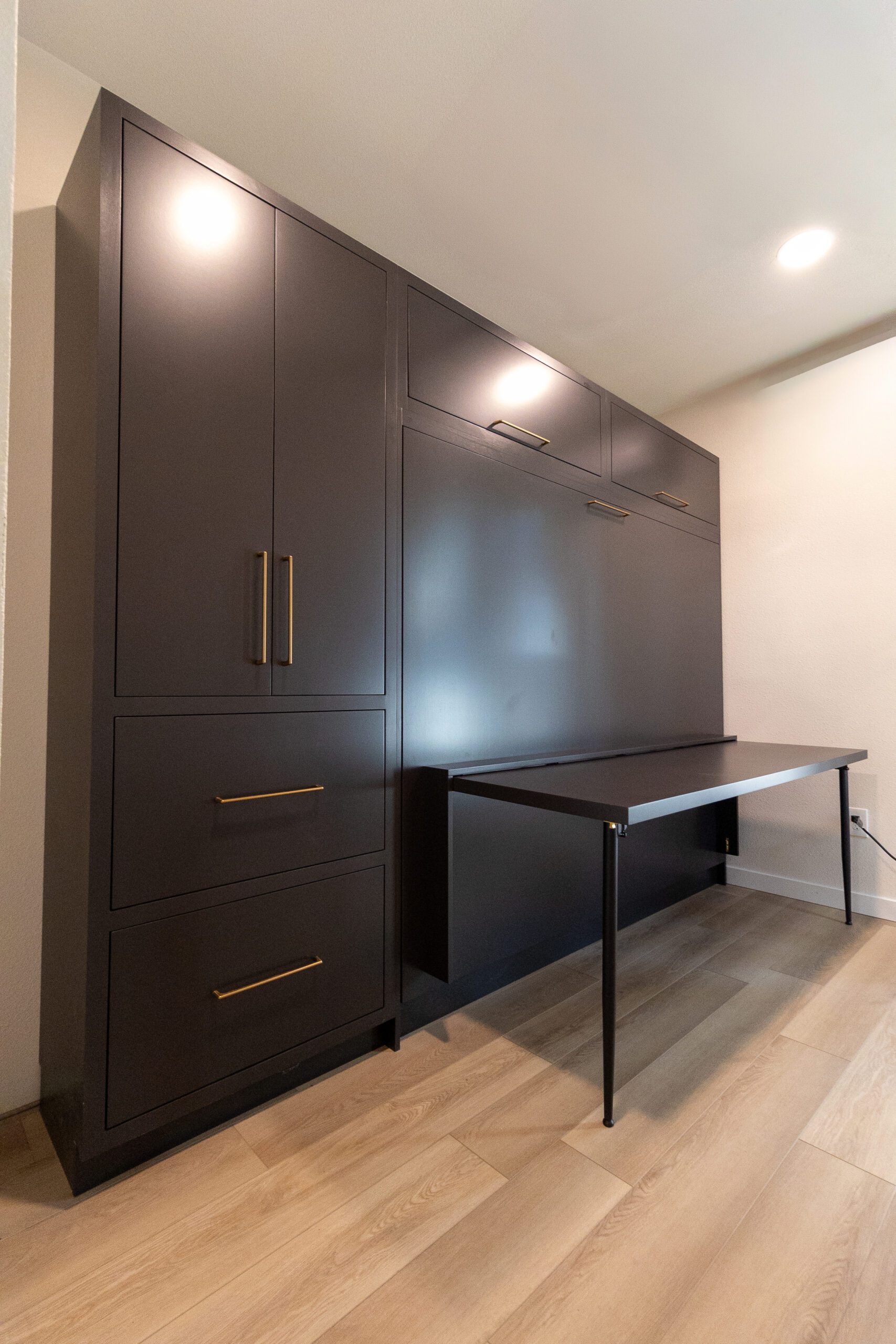 Queen horizontal Murphy bed with open drop-down desk and built-in cabinetry, espresso finish with gold pulls, Austin TX