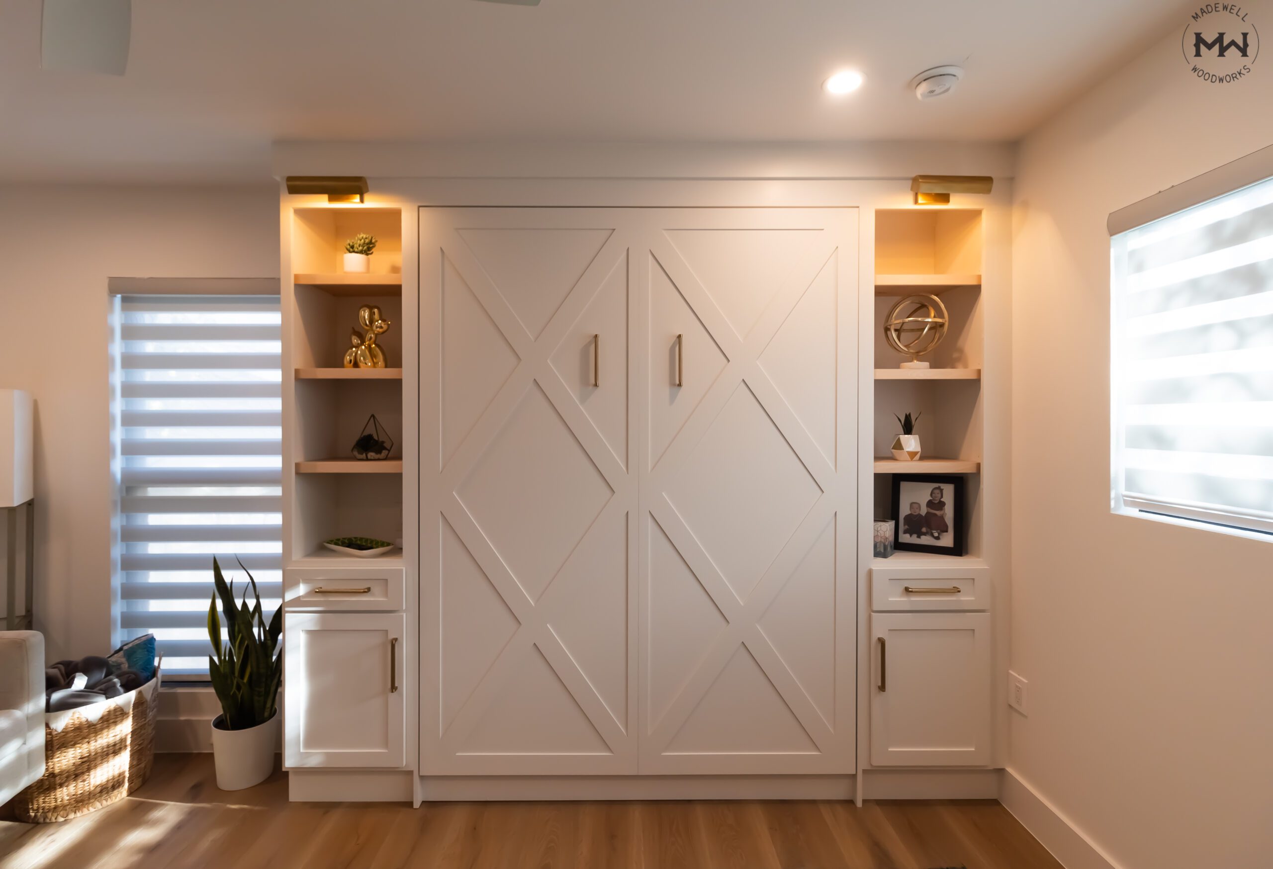 Queen vertical Crestview Murphy bed with lit open shelving towers and drawer bases, Super White finish with gold pulls, Northwest Hills Austin TX