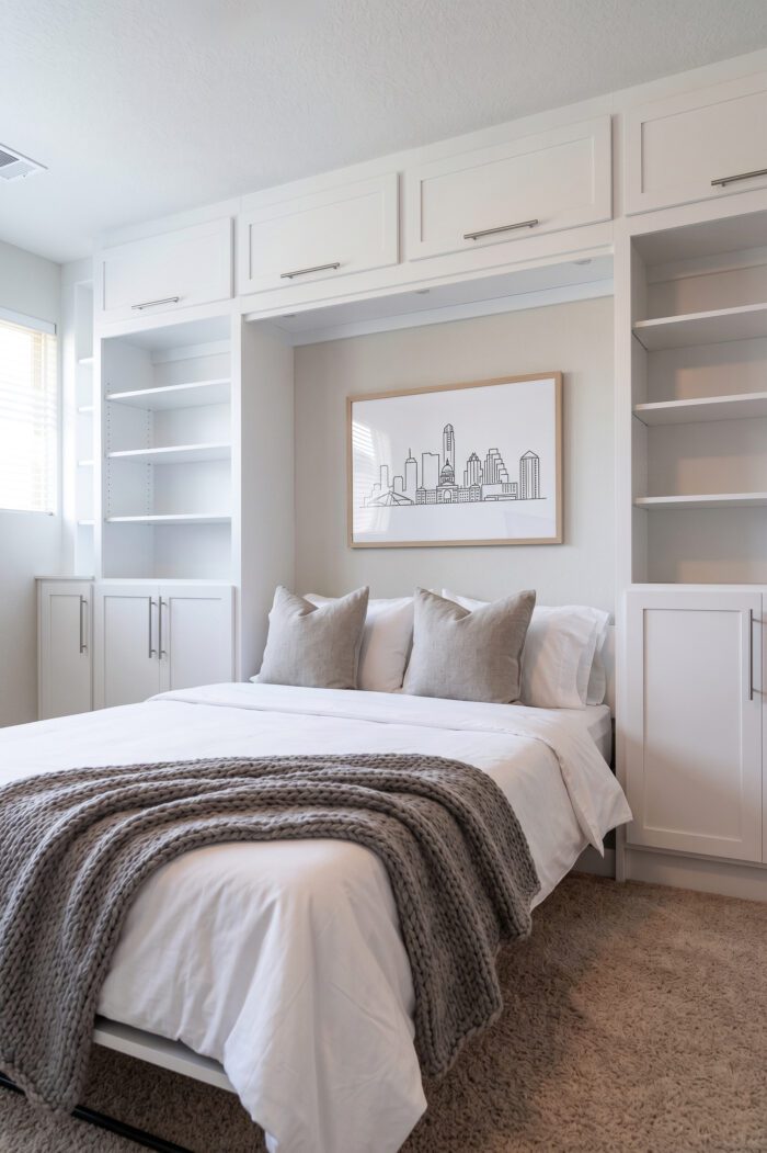 Queen vertical Rivington Murphy bed deployed with upper cabinets and open shelving towers, Super White finish, Avery Ranch Austin TX