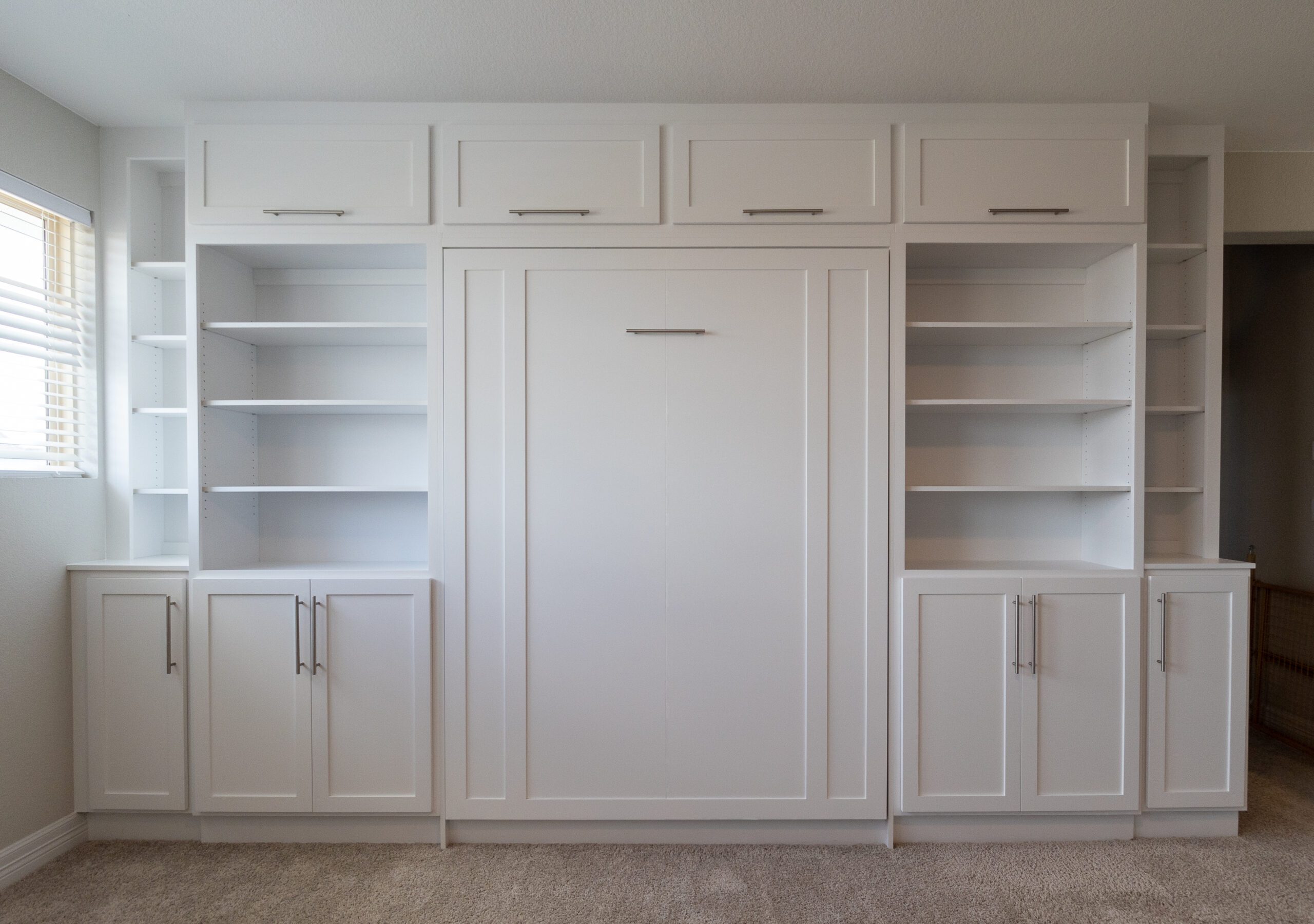 Queen vertical Rivington Murphy bed with upper cabinets, open shelving towers, and base cabinets, Super White finish, Avery Ranch Austin TX