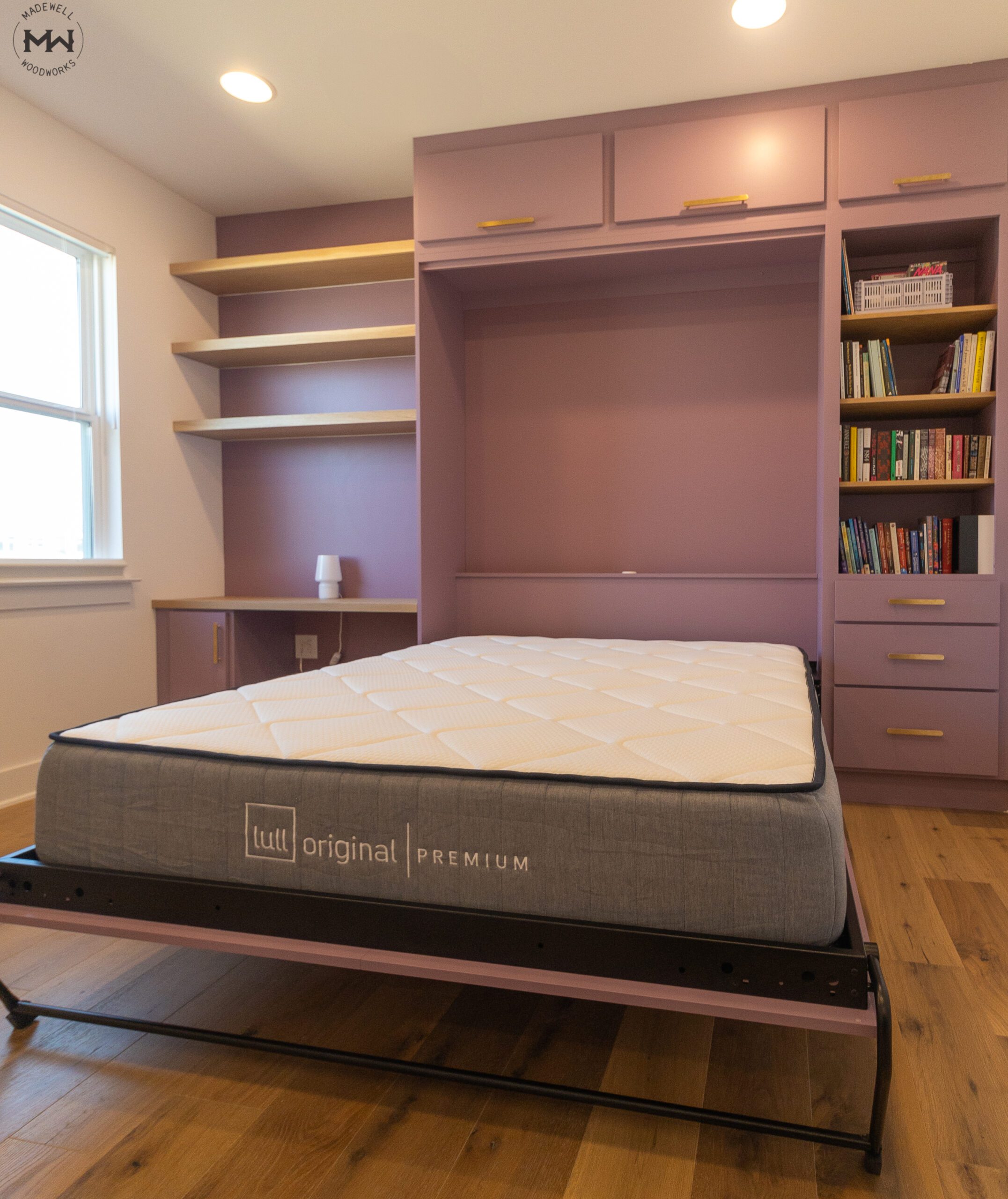 Queen vertical Velar Murphy bed deployed with white oak shelving and desk, orchid purple finish with gold pulls, Austin TX